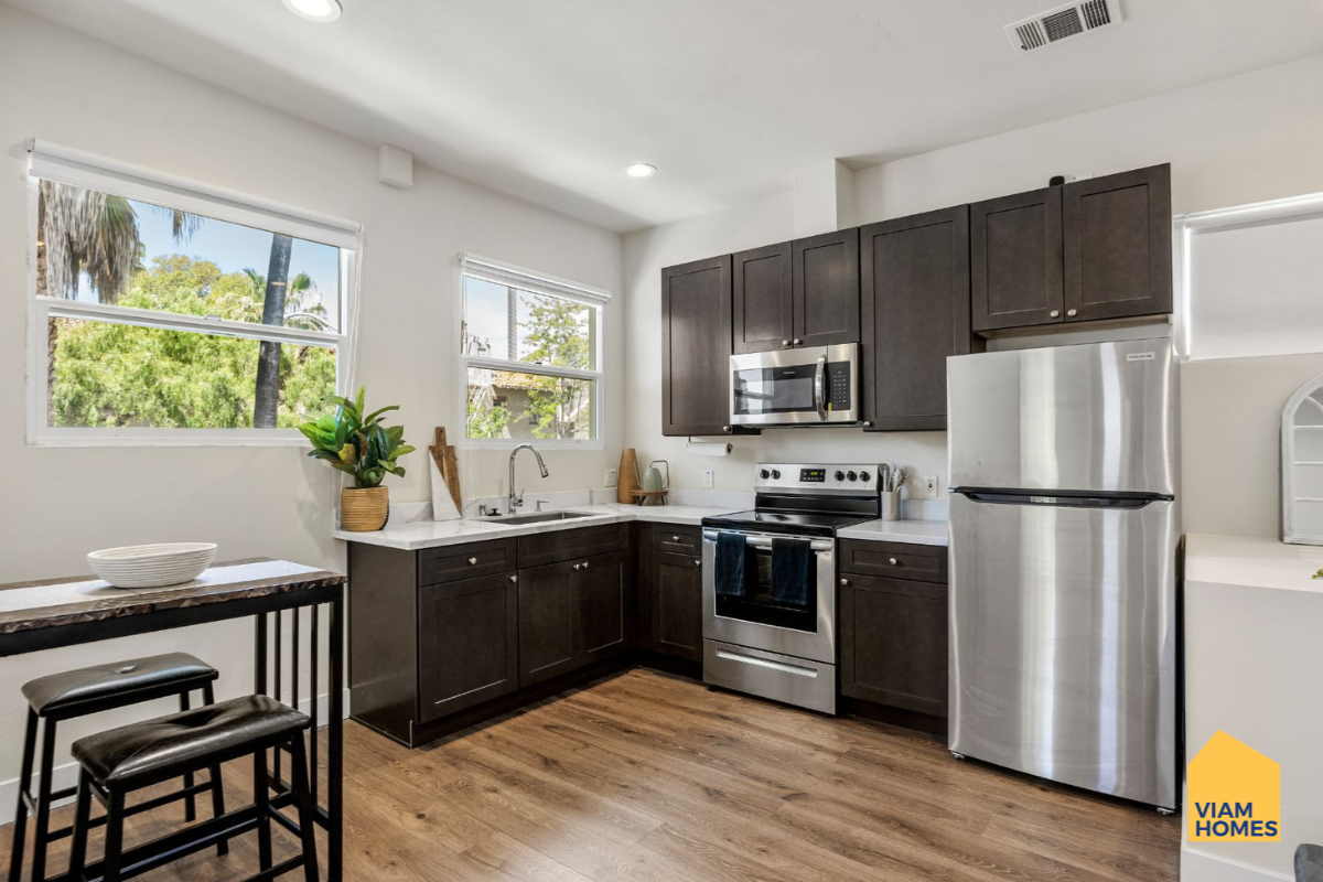 Furnished kitchen and dining area inside a 1-bedroom apartment