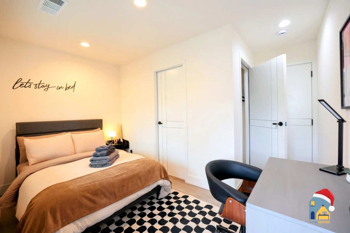 Cozy holiday bedroom with warm lighting in a furnished rental by VIAM Homes